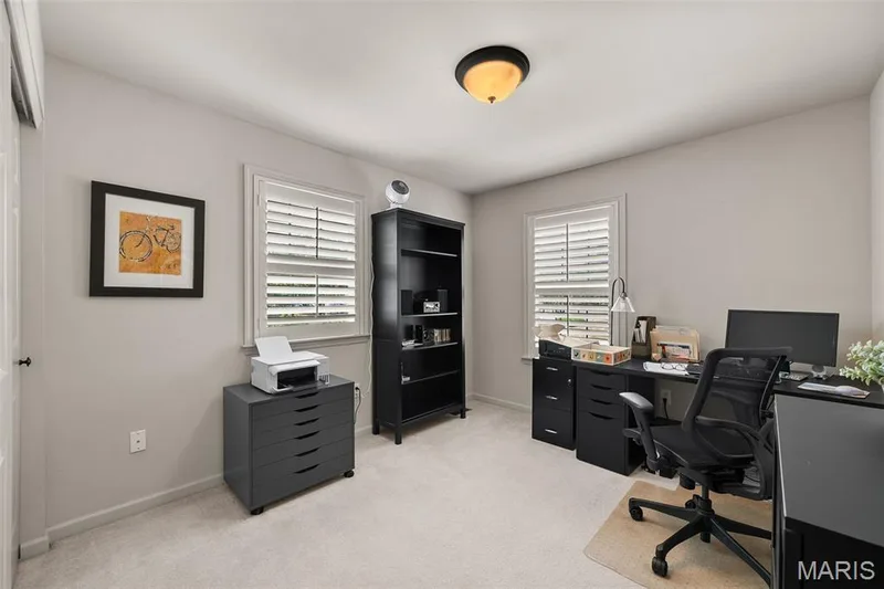 Room featuring two windows with louvered shutters, light neutral wall paint, and a semi-flush mount ceiling light — 2700 Grover Crossing Drive, Wildwood, MO 63040