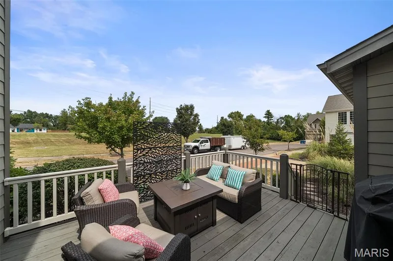 Expansive outdoor deck with railing, decorative metal privacy screen, and exterior siding — 2700 Grover Crossing Drive, Wildwood, MO 63040