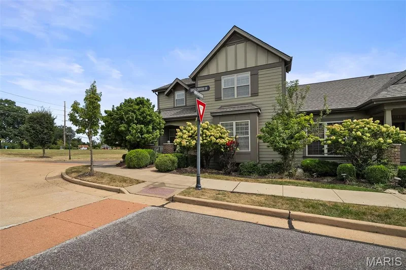 Siding exterior with multiple windows, prominent gable, and mature landscaping — 2700 Grover Crossing Drive, Wildwood, MO 63040