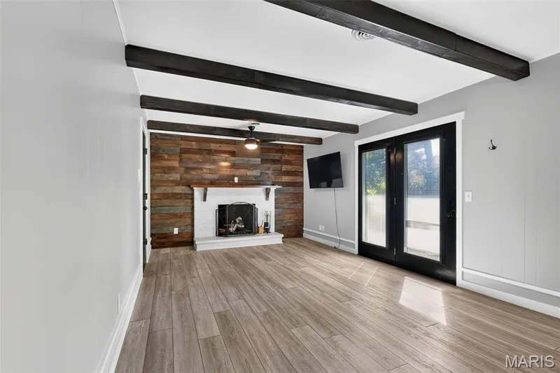 Luxury vinyl plank floor, fireplace, French door leading to patio — 120 S Duchesne Drive, St Charles, MO 63301