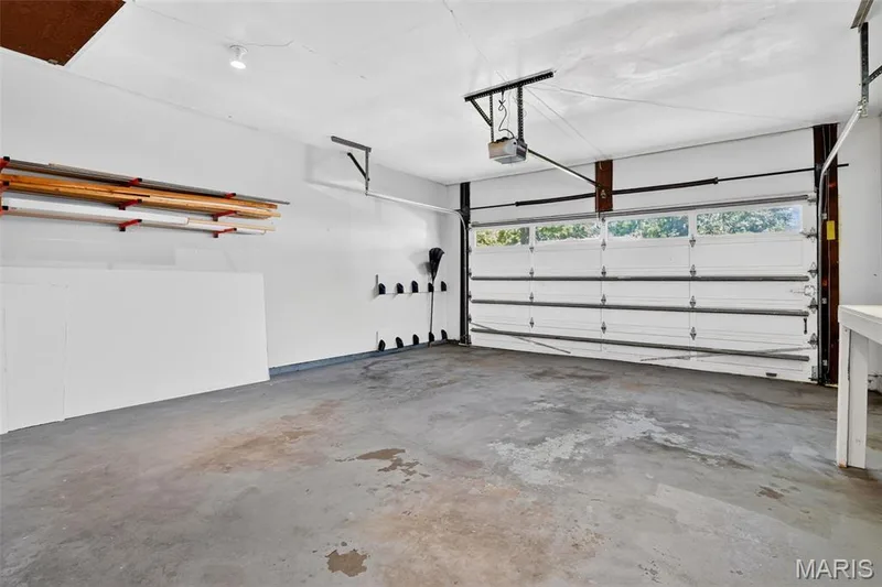 Garage with workbench, garage door opener, shelving — 120 S Duchesne Drive, St Charles, MO 63301
