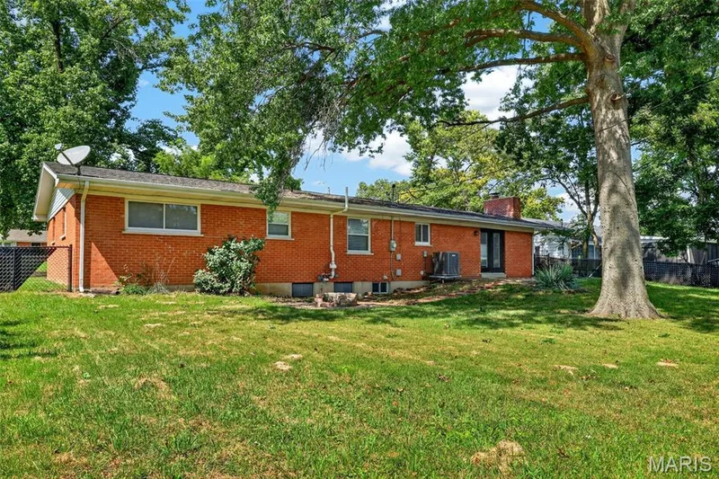 Back of house with patio and stairs leading to the fire pit — 120 S Duchesne Drive, St Charles, MO 63301