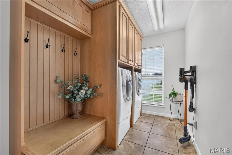 Main floor laundry room with bench seating - washer & dryer stay! — 7159 Heartland Drive, Dardenne Prairie, MO 63368