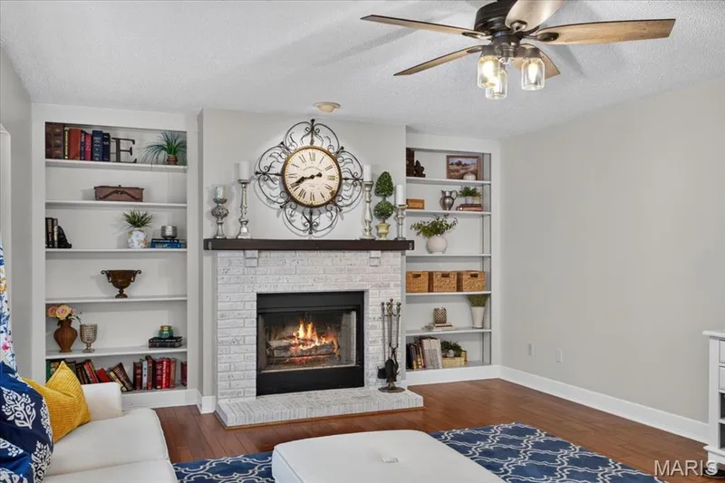Wood-burning fireplace with built-in bookshelves! — 7159 Heartland Drive, Dardenne Prairie, MO 63368