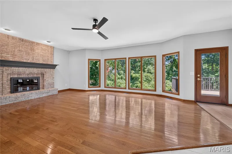 Spacious Great Room with Wood Floors, Fireplace and Additional Walkout to Deck — 4 Woodford Place, St Charles, MO 63301