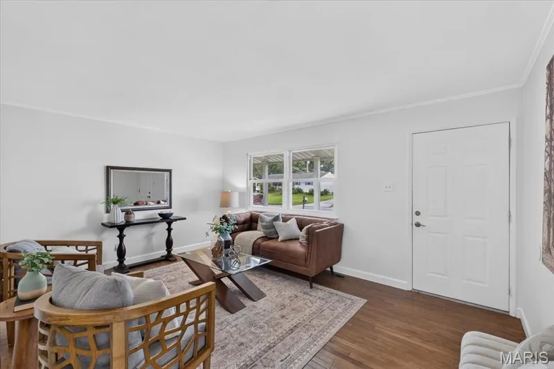 Hardwood flooring, painted interior walls, crown molding, and a paneled entry door — 11 Toelle Drive, St Charles, MO 63304