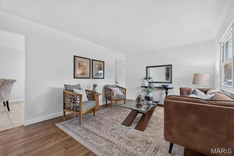 Hardwood flooring throughout, white painted walls, and a large window — 11 Toelle Drive, St Charles, MO 63304