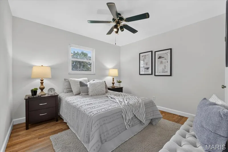 Hardwood flooring, light gray wall finishes, white trim, and a ceiling fan with integrated lighting — 11 Toelle Drive, St Charles, MO 63304