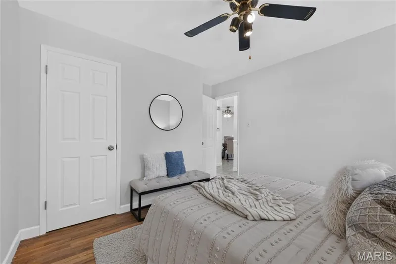 Wood-finish flooring, white paneled door, and a ceiling fan with integrated lighting — 11 Toelle Drive, St Charles, MO 63304