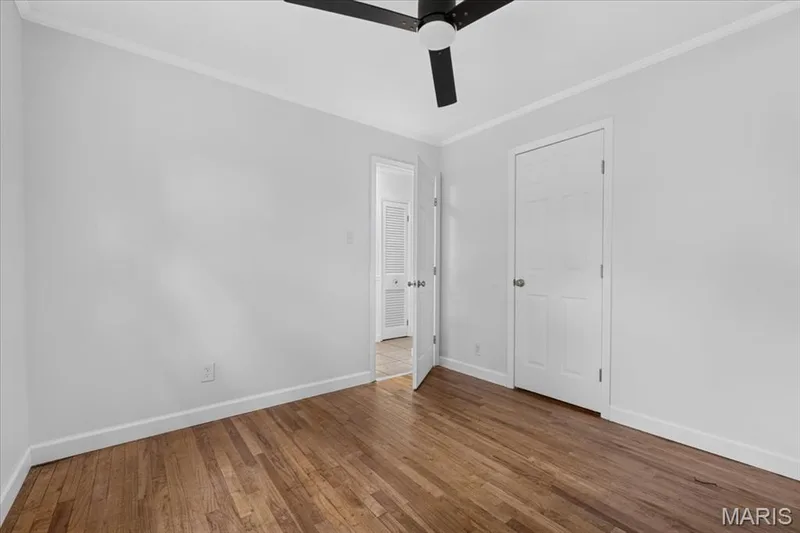 Hardwood flooring, painted white walls, crown molding, ceiling fan, white paneled doors — 11 Toelle Drive, St Charles, MO 63304