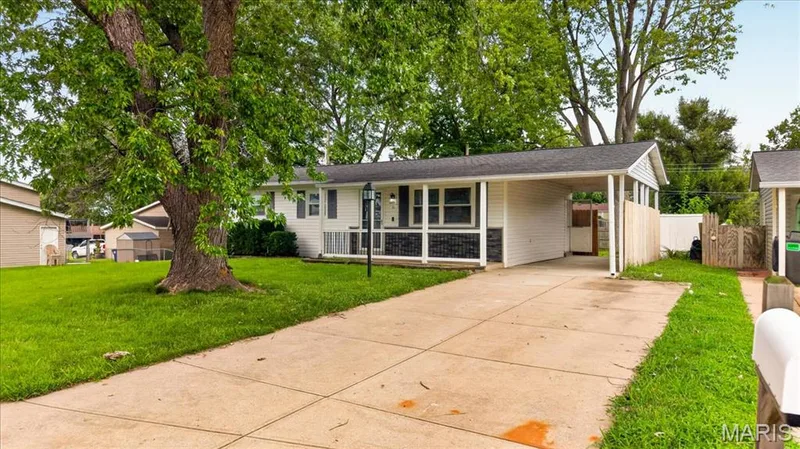 Single-story residence featuring white siding, a covered entry, and a carport — 11 Toelle Drive, St Charles, MO 63304