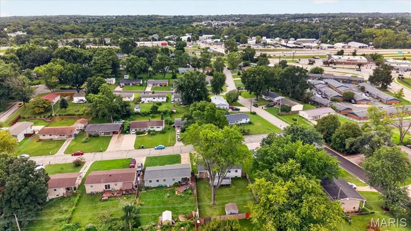 Residential neighborhood with single-story homes, mature trees, and paved streets — 11 Toelle Drive, St Charles, MO 63304