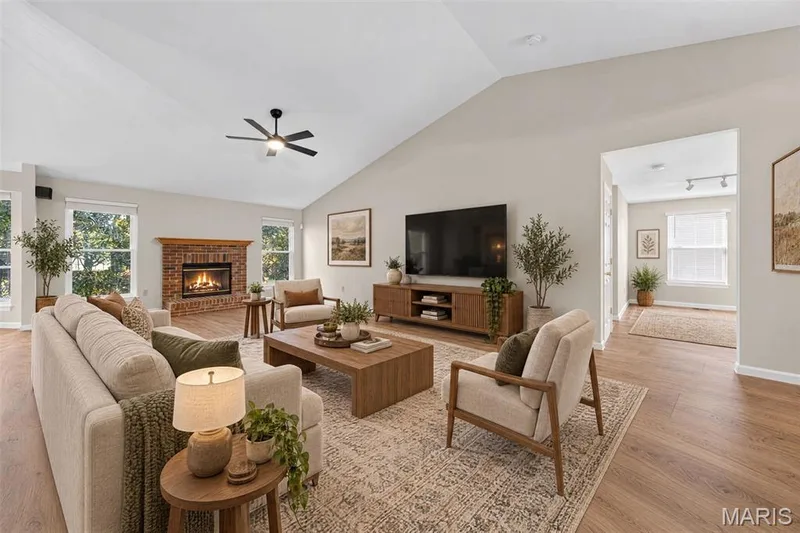 Vaulted ceiling, wood-finish flooring, brick fireplace with mantel, ceiling fan, and recessed lighting — 155 Snake River Drive, Dardenne Prairie, MO 63368