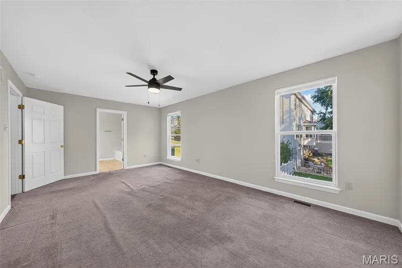 Spacious room with gray wall paint and dark carpet flooring — 155 Snake River Drive, Dardenne Prairie, MO 63368