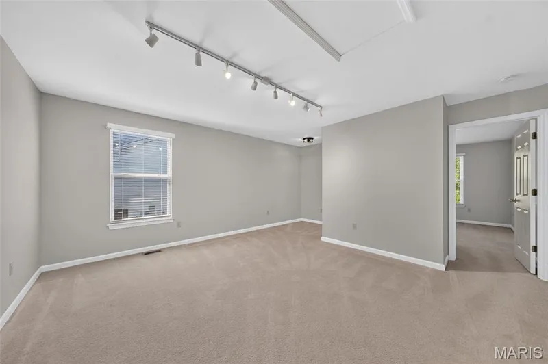 Spacious room featuring neutral carpeting, light gray wall paint, and recessed lighting — 155 Snake River Drive, Dardenne Prairie, MO 63368
