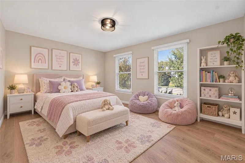 Wood-finish flooring with a neutral wall color, two double-hung windows, a built-in white shelving unit, and a flush mount ceiling light — 155 Snake River Drive, Dardenne Prairie, MO 63368