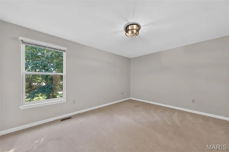 Neutral wall paint, plush carpet flooring, and a contemporary flush-mount ceiling light — 155 Snake River Drive, Dardenne Prairie, MO 63368