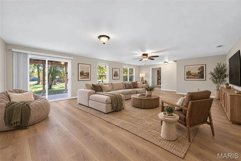 Open concept living area featuring wood-finish flooring — 155 Snake River Drive, Dardenne Prairie, MO 63368