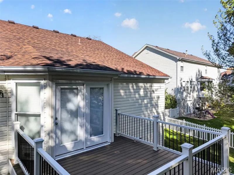 Deck with composite surface and white railings with black balusters — 155 Snake River Drive, Dardenne Prairie, MO 63368