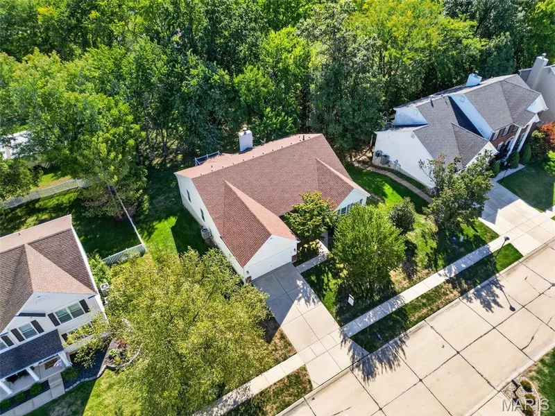 Residential property featuring a shingle roof, attached garage, and a concrete driveway — 155 Snake River Drive, Dardenne Prairie, MO 63368