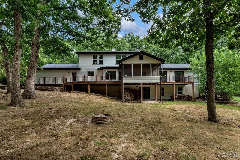 The deck spans the majority of the back of the home and includes a screened porch. — 2 Patrick Lane, Defiance, MO 63341