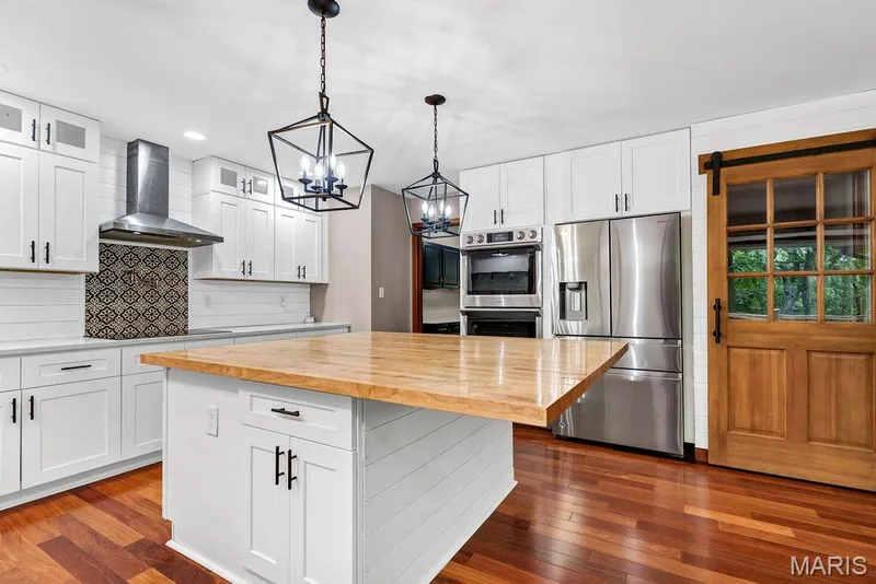 HUGE center island offers a breakfast bar overhang and will be a great spot for meal prep and when entertaining. — 2 Patrick Lane, Defiance, MO 63341