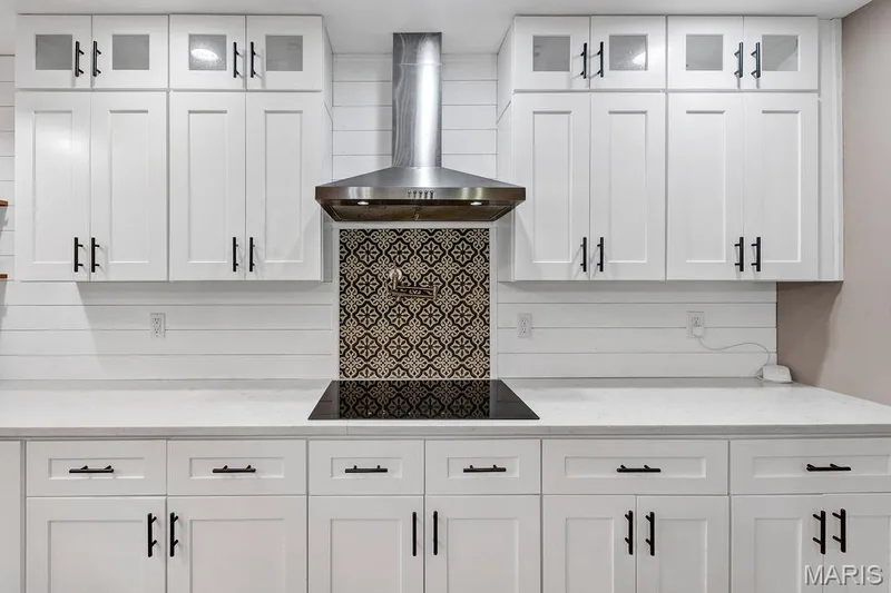 Don't miss the solid surface countertops, the shiplap details, the pot filler faucet at the electric cooktop with decorative tile blacksplash. — 2 Patrick Lane, Defiance, MO 63341