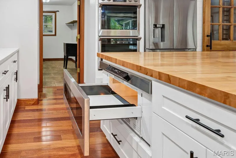 The island has a built-in drawer style microwave. — 2 Patrick Lane, Defiance, MO 63341