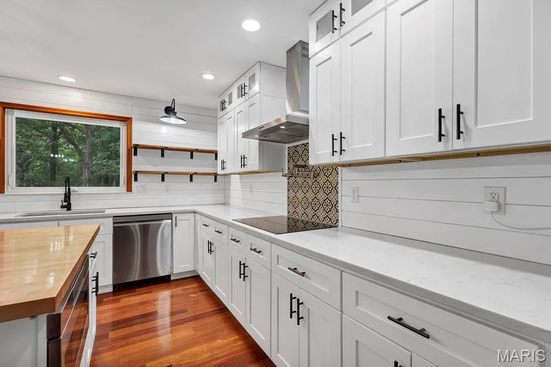 Recessed lights * Open shelving details flank the kitchen sink * Undermount stainless sink * Dishwasher — 2 Patrick Lane, Defiance, MO 63341
