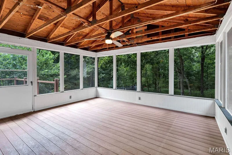 The screened porch welcomes you to relax and unwind. Perfect for sipping a delicious beverage or dining al fresco. — 2 Patrick Lane, Defiance, MO 63341