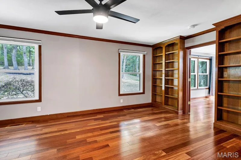 At the front of the home is a library with built-in bookshelves. — 2 Patrick Lane, Defiance, MO 63341