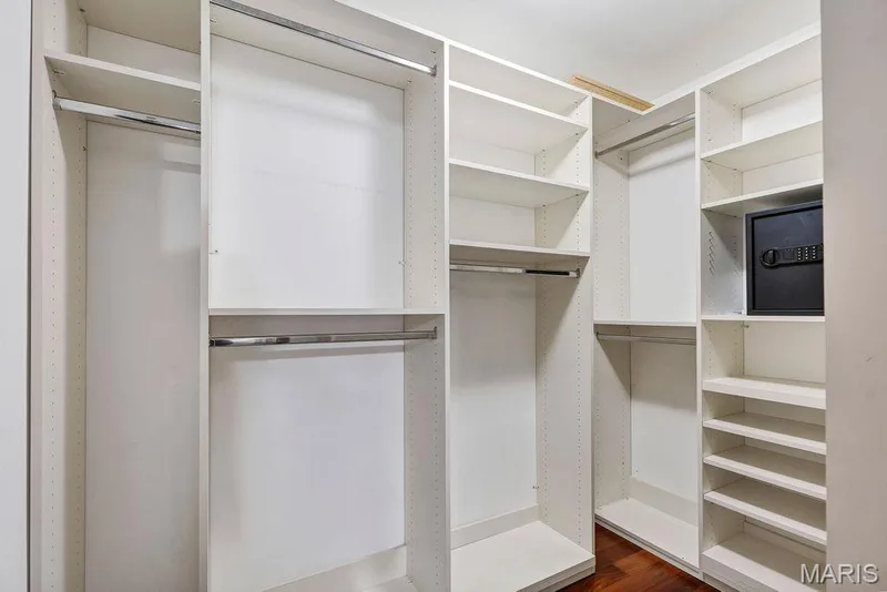 Primary bedroom walk-in closet has organizers. Please note: safe has been removed and is not included in sale. — 2 Patrick Lane, Defiance, MO 63341