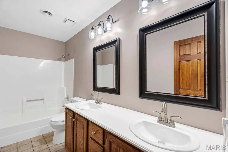 Hall bath has dual sinks and a tub/shower combination. — 2 Patrick Lane, Defiance, MO 63341