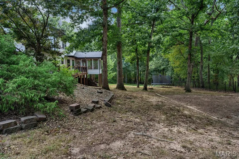 The fencing appears to be a 5' aluminum style and has double gates at the back & side nearest the chicken coop AND there are 2 single gates: one on either side of the home. — 2 Patrick Lane, Defiance, MO 63341