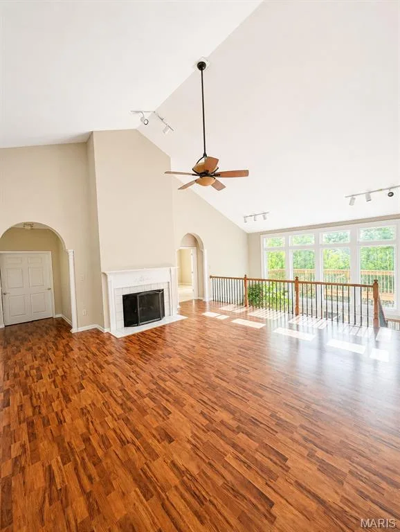 Soaring cathedral ceiling with exposed beam and pendant lighting anchors this expansive open-concept great room — 1605 Ridge Bend Drive, Glencoe, MO 63038
