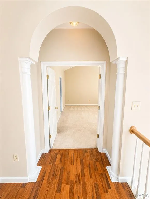 Archway entry with decorative columns, wood-finish flooring, and neutral wall tones — 1605 Ridge Bend Drive, Glencoe, MO 63038