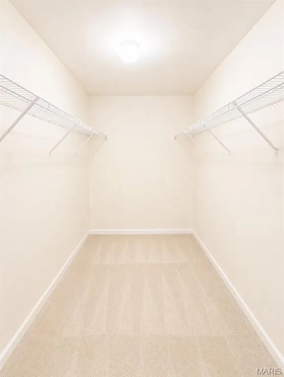 Spacious walk-in closet featuring dual wire shelving systems, recessed ceiling lighting, and light wood-finish flooring throughout — 1605 Ridge Bend Drive, Glencoe, MO 63038