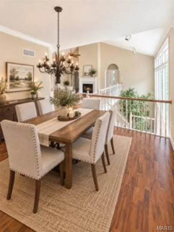 Wood-finish flooring throughout, complemented by a large chandelier and vaulted ceilings, virtually staged — 1605 Ridge Bend Drive, Glencoe, MO 63038