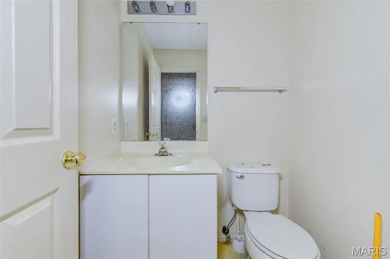 Single vanity with integrated sink, chrome faucet, and mirrored medicine cabinet — 4306 Sherman Park Drive #10F, St Charles, MO 63303