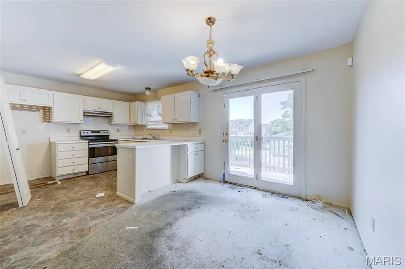 Kitchen featuring white cabinetry, stainless steel range, and a breakfast bar — 4306 Sherman Park Drive #10F, St Charles, MO 63303