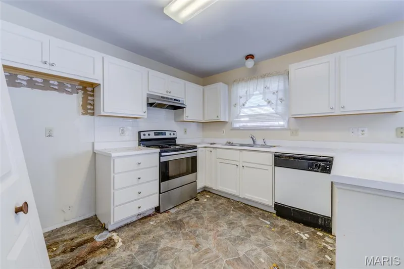 White cabinetry, stainless steel range, built-in dishwasher, and window over the sink — 4306 Sherman Park Drive #10F, St Charles, MO 63303