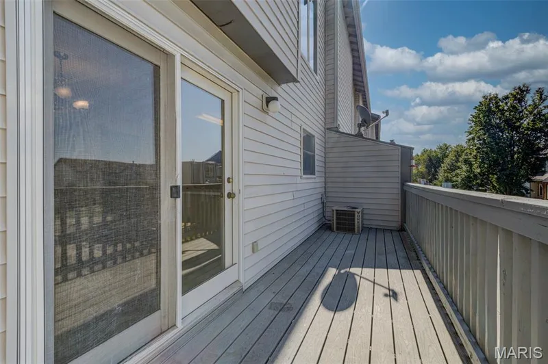 Outdoor deck with wood-finish flooring, white siding, and wood railings — 4306 Sherman Park Drive #10F, St Charles, MO 63303