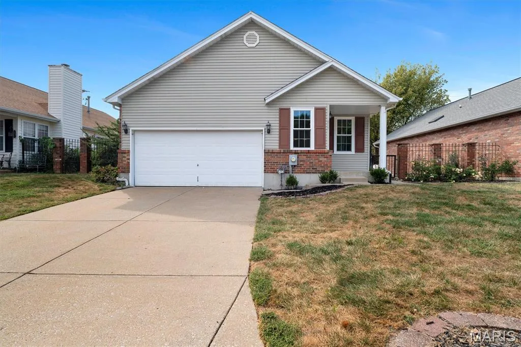 Front exterior with light-toned siding and brick veneer accents — 857 Du Pre Court, St Peters, MO 63376
