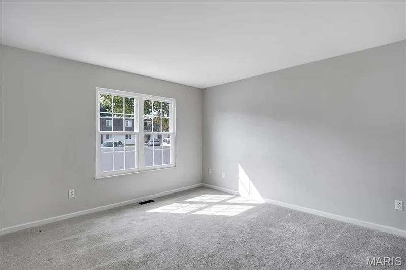 Neutral wall finishes, plush carpeting, and a double-hung window — 857 Du Pre Court, St Peters, MO 63376