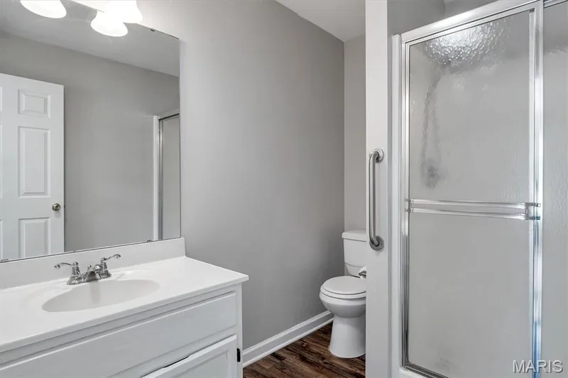 Vanity with an integrated sink, polished chrome faucet, and a wall-mounted mirror — 857 Du Pre Court, St Peters, MO 63376