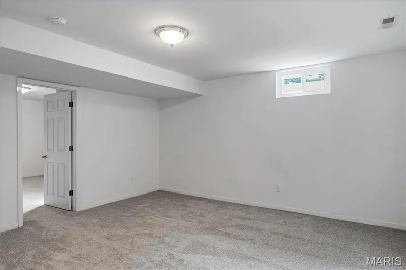 Freshly painted walls, neutral carpeting, recessed wall cut-out, ceiling-mounted light fixture, and a white interior door — 857 Du Pre Court, St Peters, MO 63376