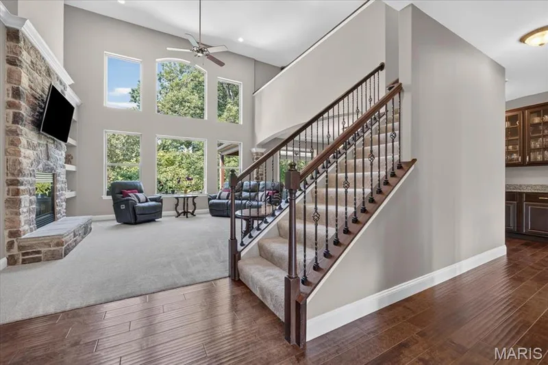 Great room featuring a gas fireplace and floor to ceiling windows — 1307 Homestead Heights Drive, Wildwood, MO 63005