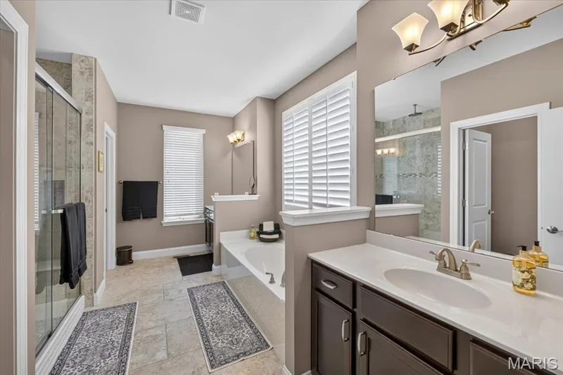 Primary bathroom with double sinks and separate bath/shower — 1307 Homestead Heights Drive, Wildwood, MO 63005