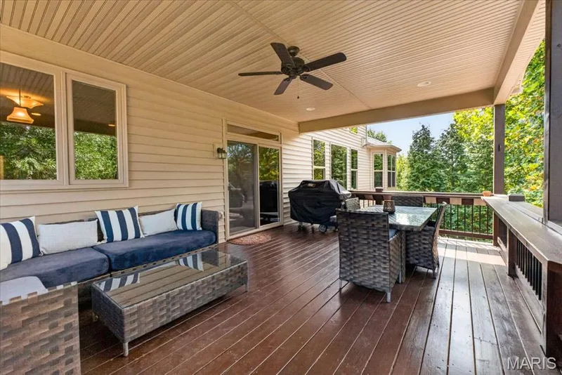 Expansive covered deck featuring wood-finish flooring, a ceiling fan, and sliding glass door access — 1307 Homestead Heights Drive, Wildwood, MO 63005