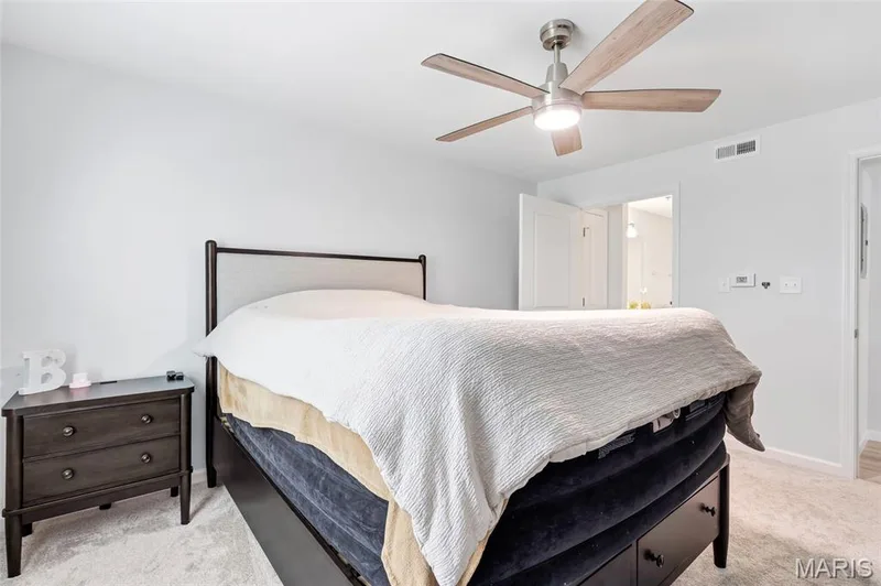 Cozy primary bedroom suite is conveniently adjacent to the large primary bathroom. — 4101 Spring Creek Lane, O'Fallon, MO 63368